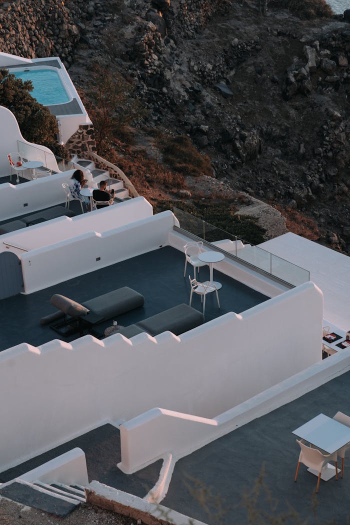 Stunning hilltop resort with elegant pools and terraces, offering a scenic view.