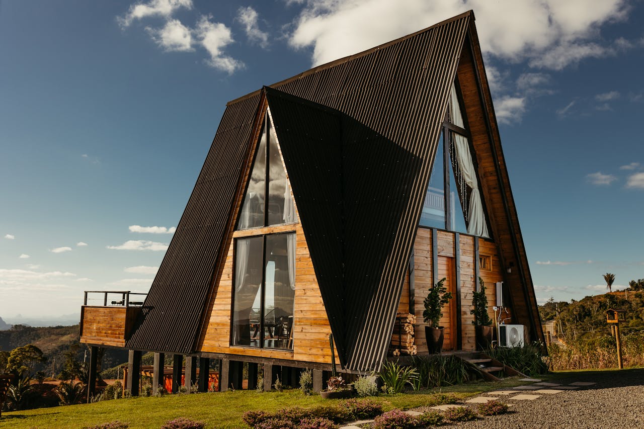 A picturesque A-frame wooden cabin on stilts amidst lush greenery in Brazils rural landscape.